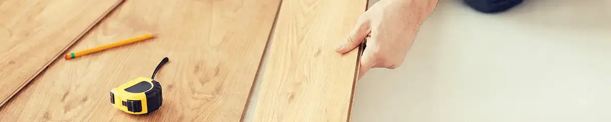 A professional installing wood flooring in Erie, PA