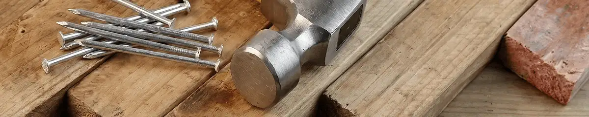 Hammer and nails on hardwood flooring boards in Erie, PA