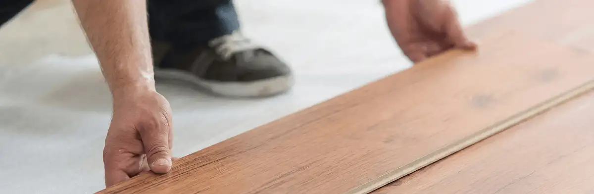 A professional installing laminate flooring in Erie, PA