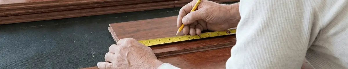 A professional installing wood flooring in Erie, PA